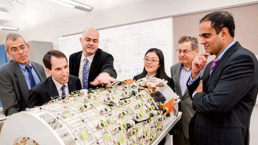 Researchers with a prototype of the boreliner, a massively parallel 124-channel imaging array.