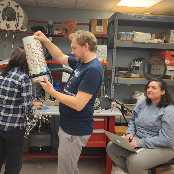 Sebastian Theilenberg seen examining the multicoil active shim in NYU Langone's RF lab.