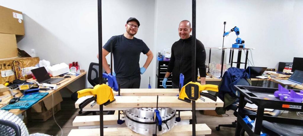 Leeor Alon and Vito Ciancia seen standing by the partially assembled magnet.