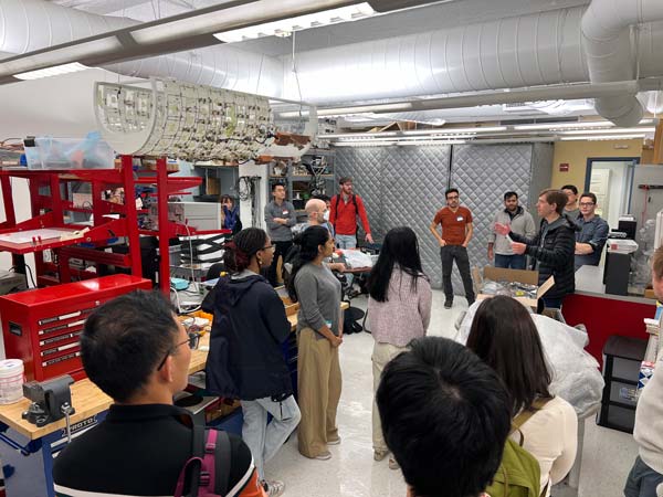 Jason Stockmann seen addressing hackathon participants in NYU Langone's RF lab.