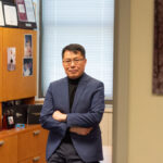 Yulin Ge seen standing in his office.