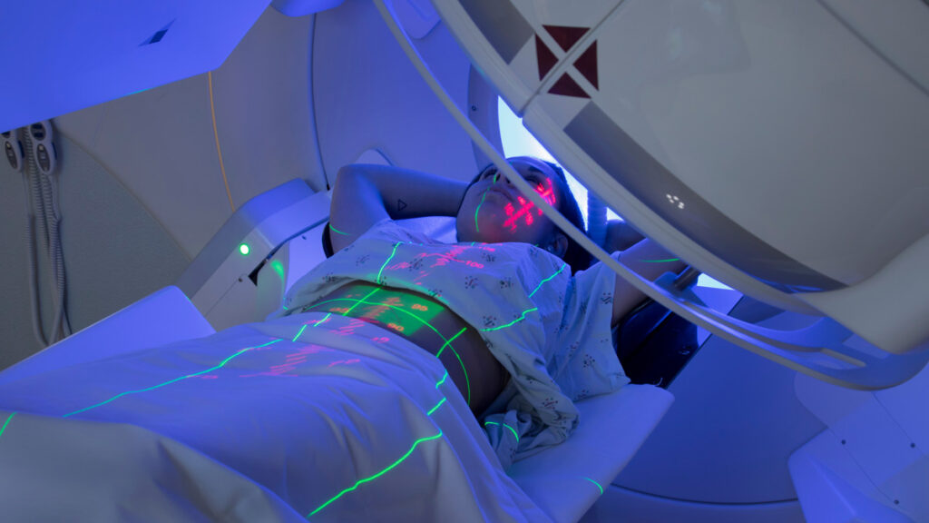 Photo: a person on a linear accelerator machine.