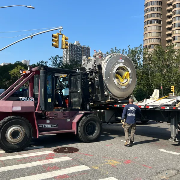 Photo: Forklift putting an MRI magnet on a the bed of a cargo trailer.
